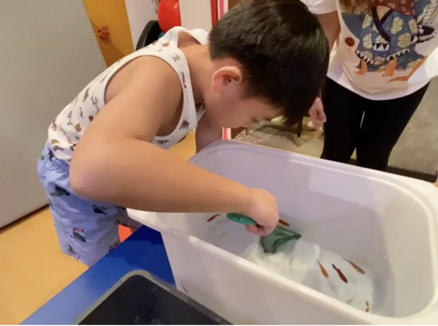 Image of a student at ONE Intervention Centre enjoying hands-on learning of a biology lesson.