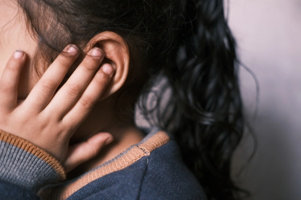 Girl covering ears due to sensory issues in adults