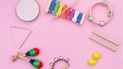 Various instruments scattered on a pink background, including a xylopohne, tambourine, and shakers. A sign of dyslexia could be poor auditory discrimination leading to difficulty in telling apart these instruments.
