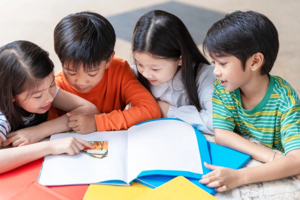 A group of children reading around a table