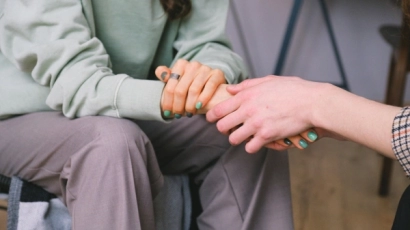 Hands clasped to illustrate that a strength of dyslexia is empathy