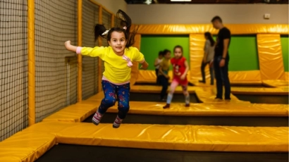 Children bouncing in an indoor trampoline park. Jolly Jungle, one of the kids' indoor playgrounds featured on this list, has a similar Bounce Area.