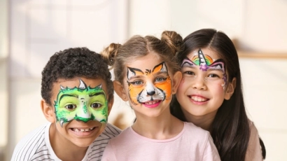 Children with their faces painted as dragons, tigers and unicorns