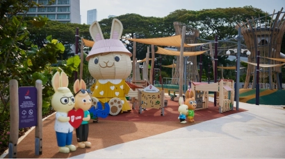 Playground at Propnex Family Zone, featuring a giant inflatable bunny and various playground equipment. Propnext Family Zone is a family-friendly garden.