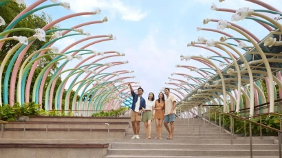 Family posing in front of the entrance of Sentosa Sensoryscape, a sensory playground on this list
