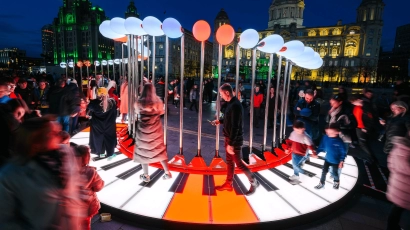 Piano Walk at iLight, where people are walking across an exhibit of a neon piano that lights up. This is a fun activity that you can take your kids to for the June Holidays.