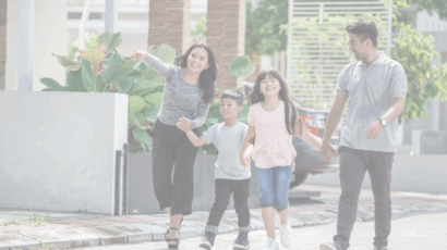 Two parents and two children walk outside house, children learning how to speak up at home