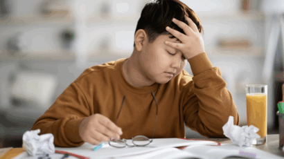Boy feeling frustration over homework, which is common if they focus solely on high grades