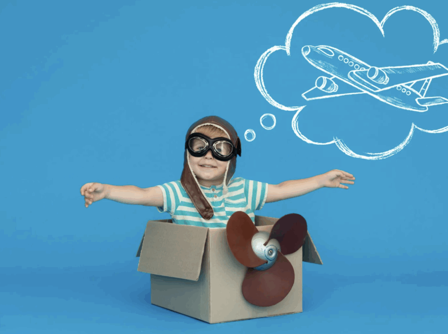 Boy pretending to be a pilot, representing fantasy play