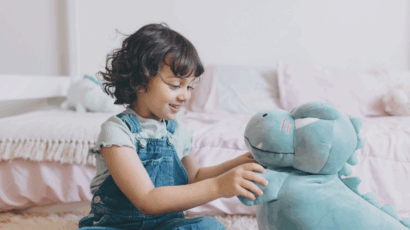 Girl playing with stuffed animal, which is a good fantasy play idea